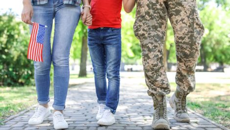 A military family holding hands.
