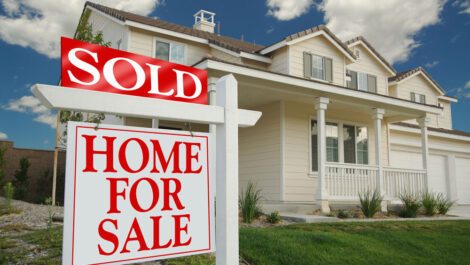 Home with a sold sign in front yard.