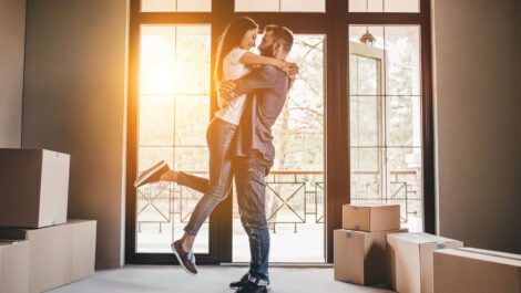 Man hugging a woman in a new home.