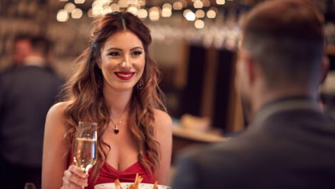 Young couple eating dinner at a fancy restaurant.