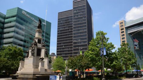A statue and large buildings in Campus Martius Park in Detroit.