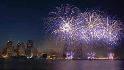 Fourth of July fireworks next to city.