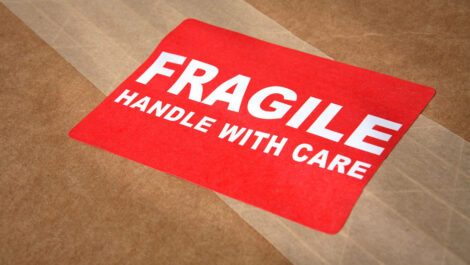Fragile Handle With Care sticker on a box.