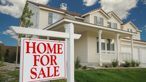 Home For Sale sign in front of a house.