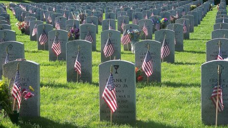 Veteran graveyard with a small American flag by each grave.