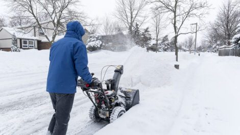 Man clearing snow with a snow blower.