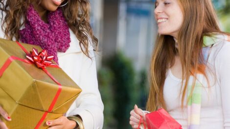 Two young women holiday shopping together.