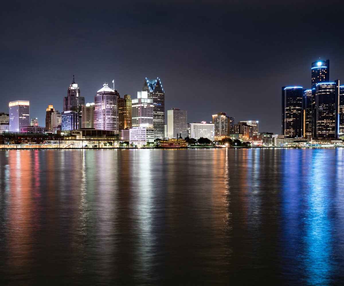 City skyline next to lake at night.