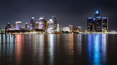 City skyline next to lake at night.